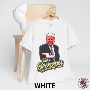 White T‑shirt featuring a pop‑art grunge illustration of President Trump holding a bee in his hand with bold ‘The Beekeeper’ text below.