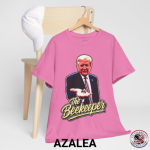 Azalea T‑shirt featuring a pop‑art grunge illustration of President Trump holding a bee in his hand with bold ‘The Beekeeper’ text below.