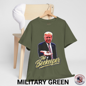 Military Green T‑shirt featuring a pop‑art grunge illustration of President Trump holding a bee in his hand with bold ‘The Beekeeper’ text below.