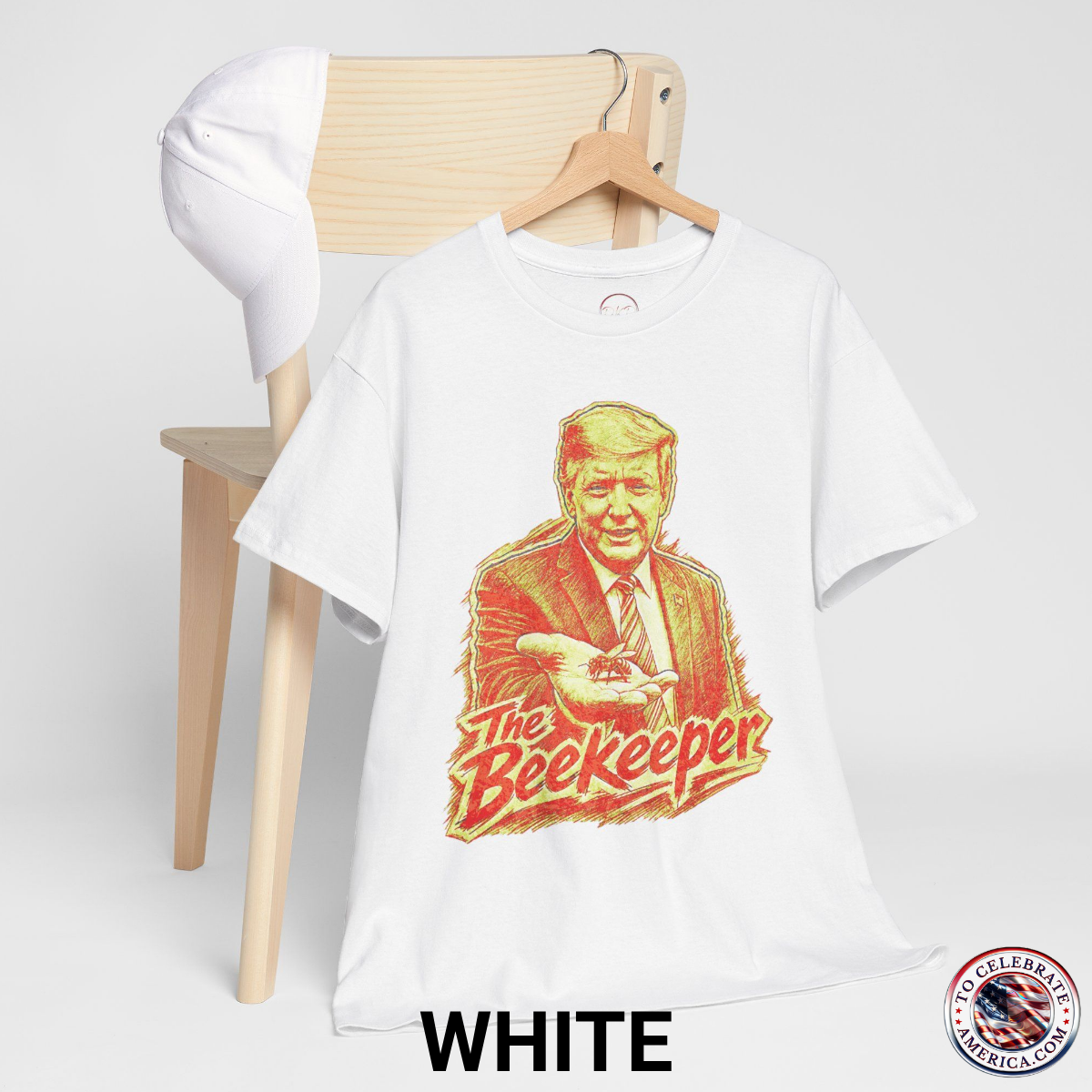 White T‑shirt featuring a pencil‑sketch illustration of President Trump holding a small bee in an outstretched hand, with stylized ‘The Beekeeper’ text below.