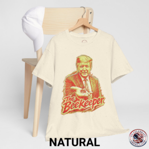 Natural Pale Yellow T‑shirt featuring a pencil‑sketch illustration of President Trump holding a small bee in an outstretched hand, with stylized ‘The Beekeeper’ text below.