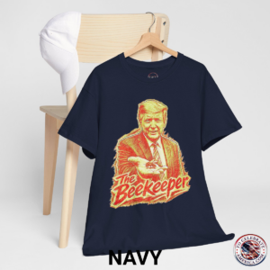 Navy T‑shirt featuring a pencil‑sketch illustration of President Trump holding a small bee in an outstretched hand, with stylized ‘The Beekeeper’ text below.
