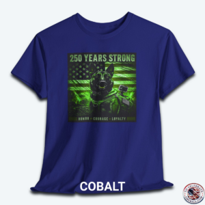 A Cobalt blue graphic t-shirt displayed flat, featuring a night-vision green overlay design of a tactical working K9 dog in front of a weathered US flag. The text reads "250 Years Strong" at the top and "HONOR ā
COURAGE ā
LOYALTY" at the bottom.
